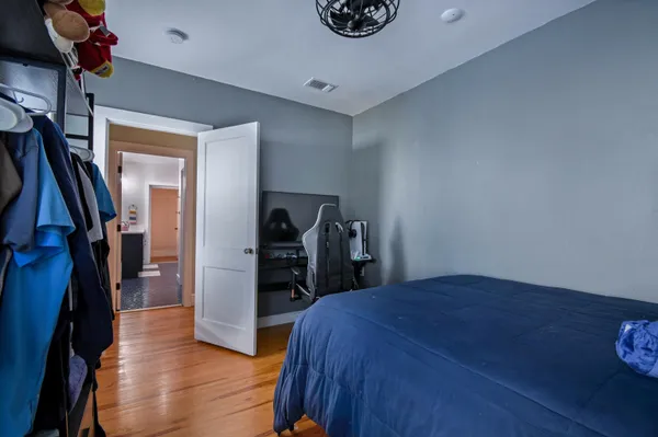 a view of empty room with wooden floor