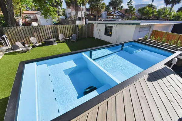 a view of a deck with table and chairs with wooden floor and fence