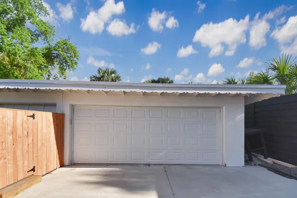 a view of a field with a big yard and a palm tree