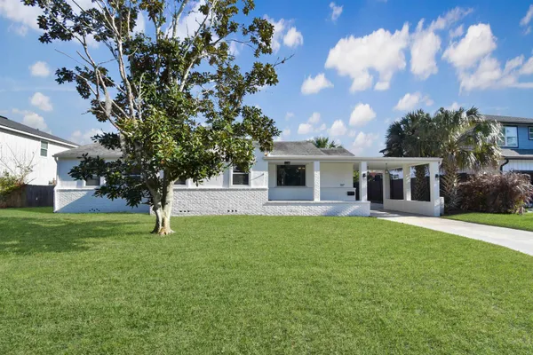 a view of a dining room with furniture a chandelier and wooden floor