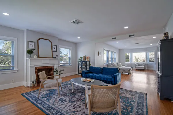 a living room with furniture and a wooden floor
