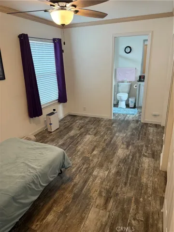 a bedroom with a bed and a mirror