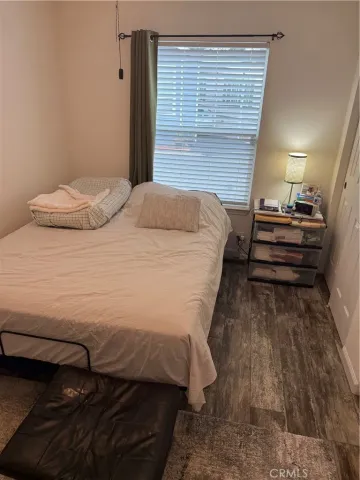 a bedroom with a bed and a ceiling fan