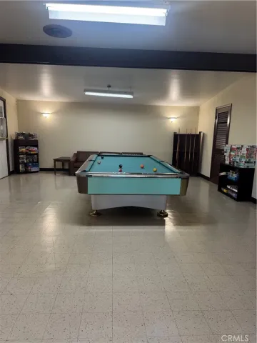 a room with pool table and windows