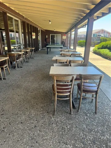 a view of a house with backyard porch and sitting area