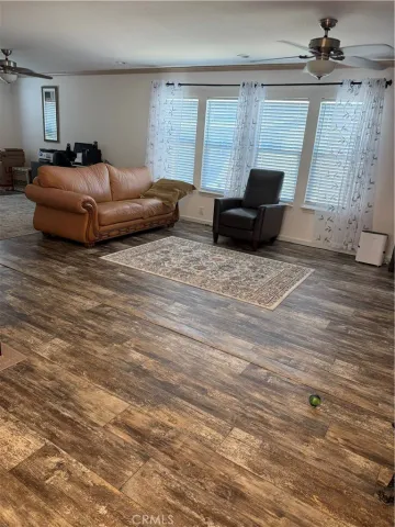 a spacious bedroom with a bed and wooden floor