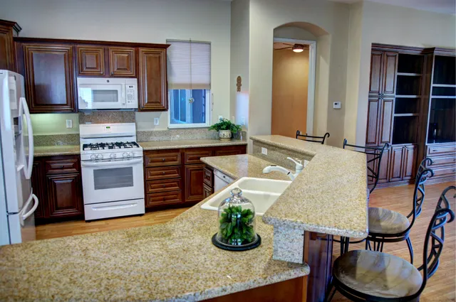 a view of a small space with wooden floor and a window