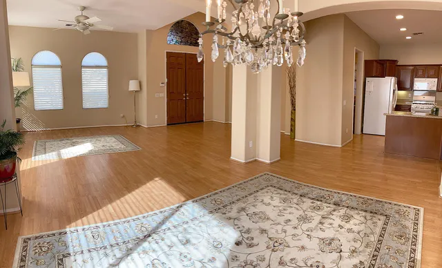 a kitchen with stainless steel appliances granite countertop a stove a sink and a refrigerator