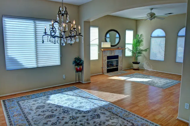 a kitchen with stainless steel appliances granite countertop a stove a sink dishwasher and a refrigerator with wooden floor