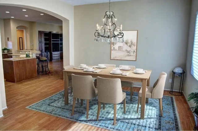 a view of an empty room with wooden floor and closet