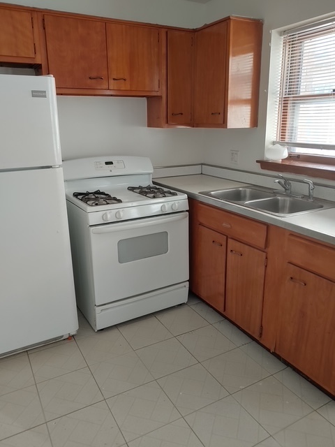14613 Keystone Avenue Midlothian, IL 60445 - Photo 14 of 16 a kitchen with granite countertop a sink a stove a refrigerator and cabinets