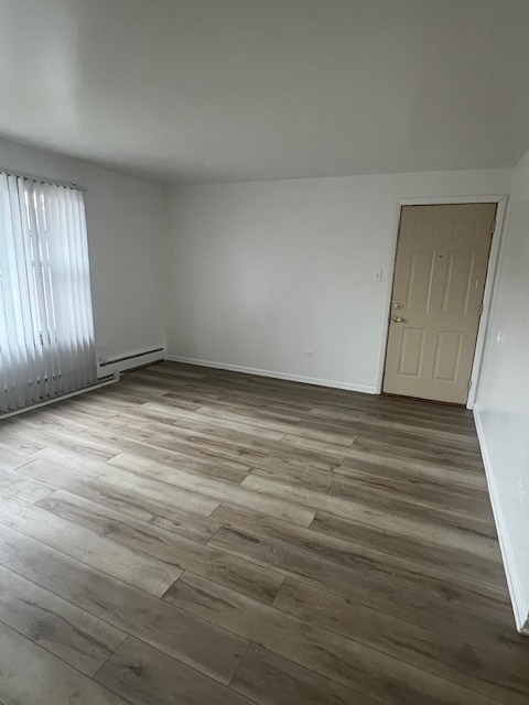 14613 Keystone Avenue Midlothian, IL 60445 - Photo 16 of 16 an empty room with wooden floor and windows