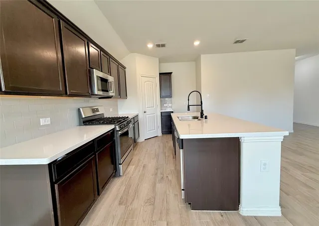 a walk in closet with empty racks