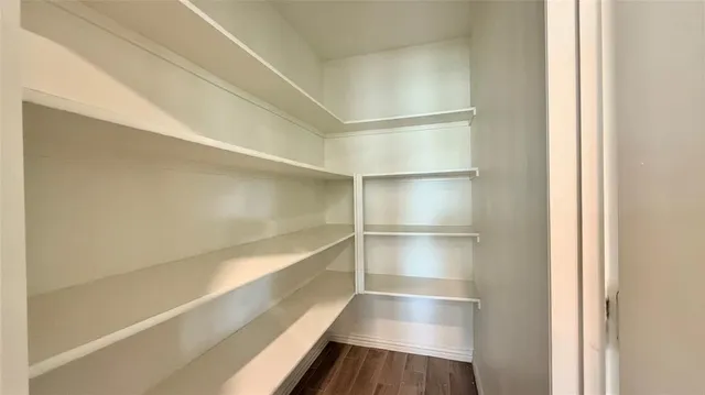 a view of a livingroom with a ceiling fan and window