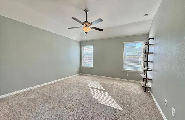 a view of a livingroom with a ceiling fan window and entryway