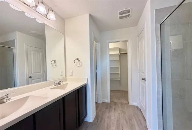 a bathroom with a glass shower door
