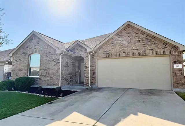a view of a house with brick walls