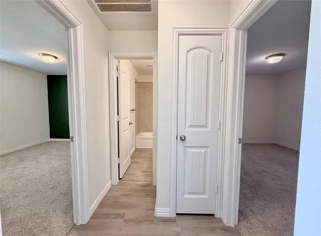 a view of a bathroom with mirror and shower
