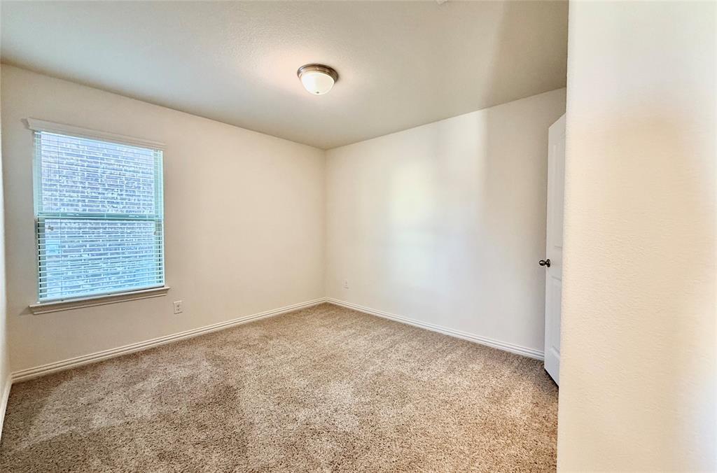 813 Evergreen Street Princeton, TX 75407 - Photo 10 of 29 a view of an empty room with a window