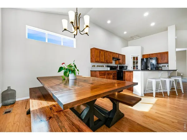 a dining room with furniture and wooden floor