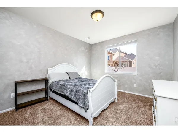 a bed room with a bed and a painting