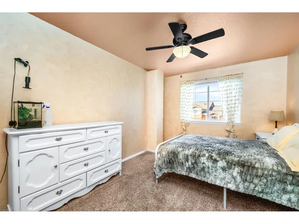 a bathroom with a sink a toilet a mirror and shower curtain