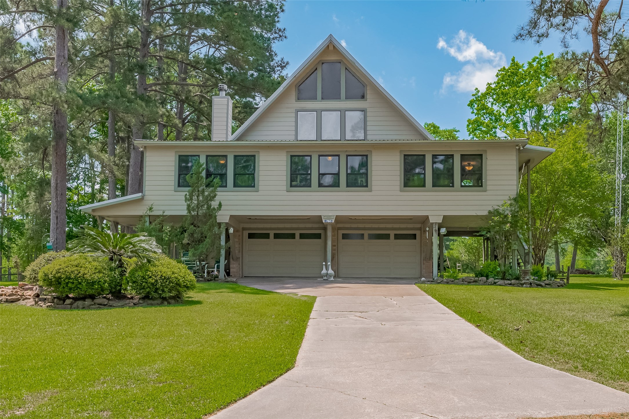 a front view of a house with a yard and trees