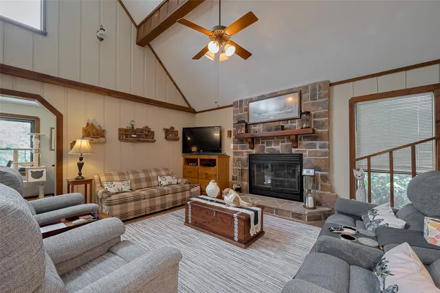 a living room with furniture fireplace and flat screen tv