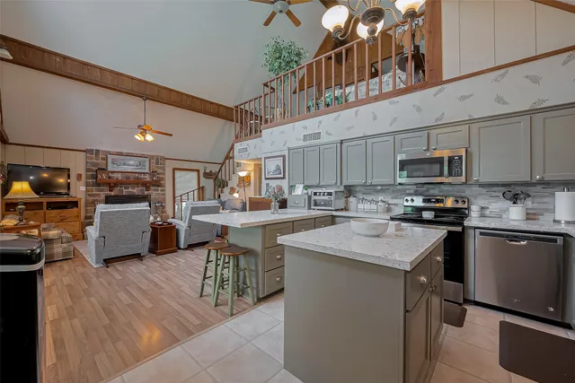 a kitchen with counter top space a sink appliances and cabinets
