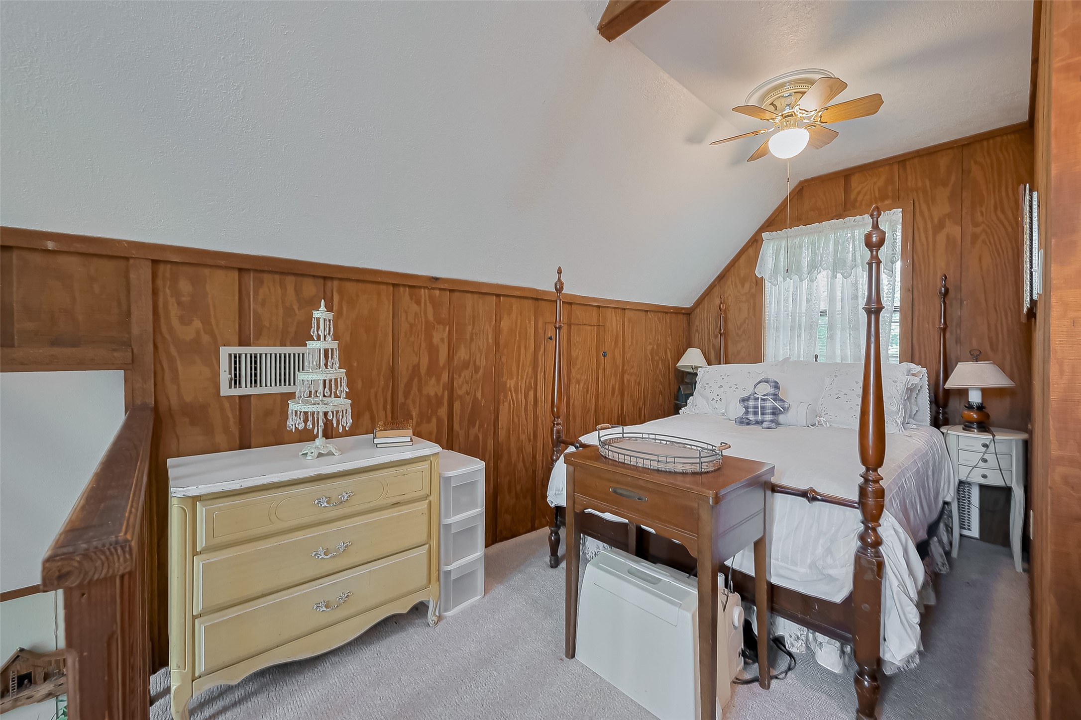 780 Hickory Ridge Drive Coldspring, TX 77331 - Photo 25 of 50 a bedroom with a bed and a chandelier