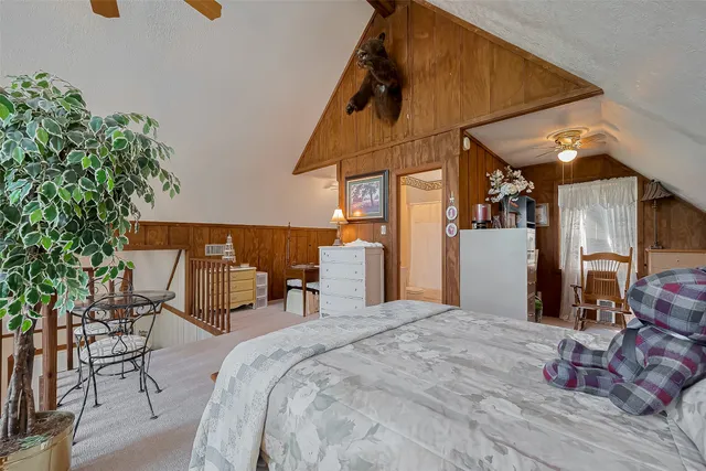 a bed room with a bed and a potted plant
