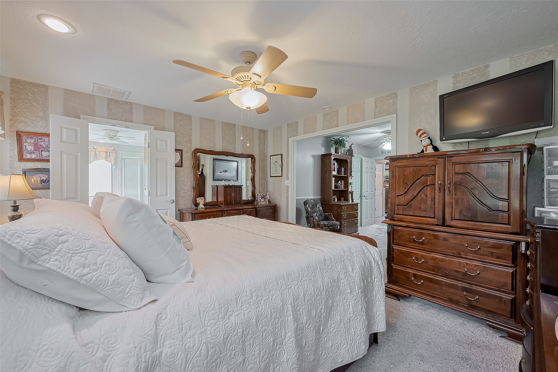 780 Hickory Ridge Drive Coldspring, TX 77331 - Photo 33 of 50 a bedroom with a bed and a flat screen tv