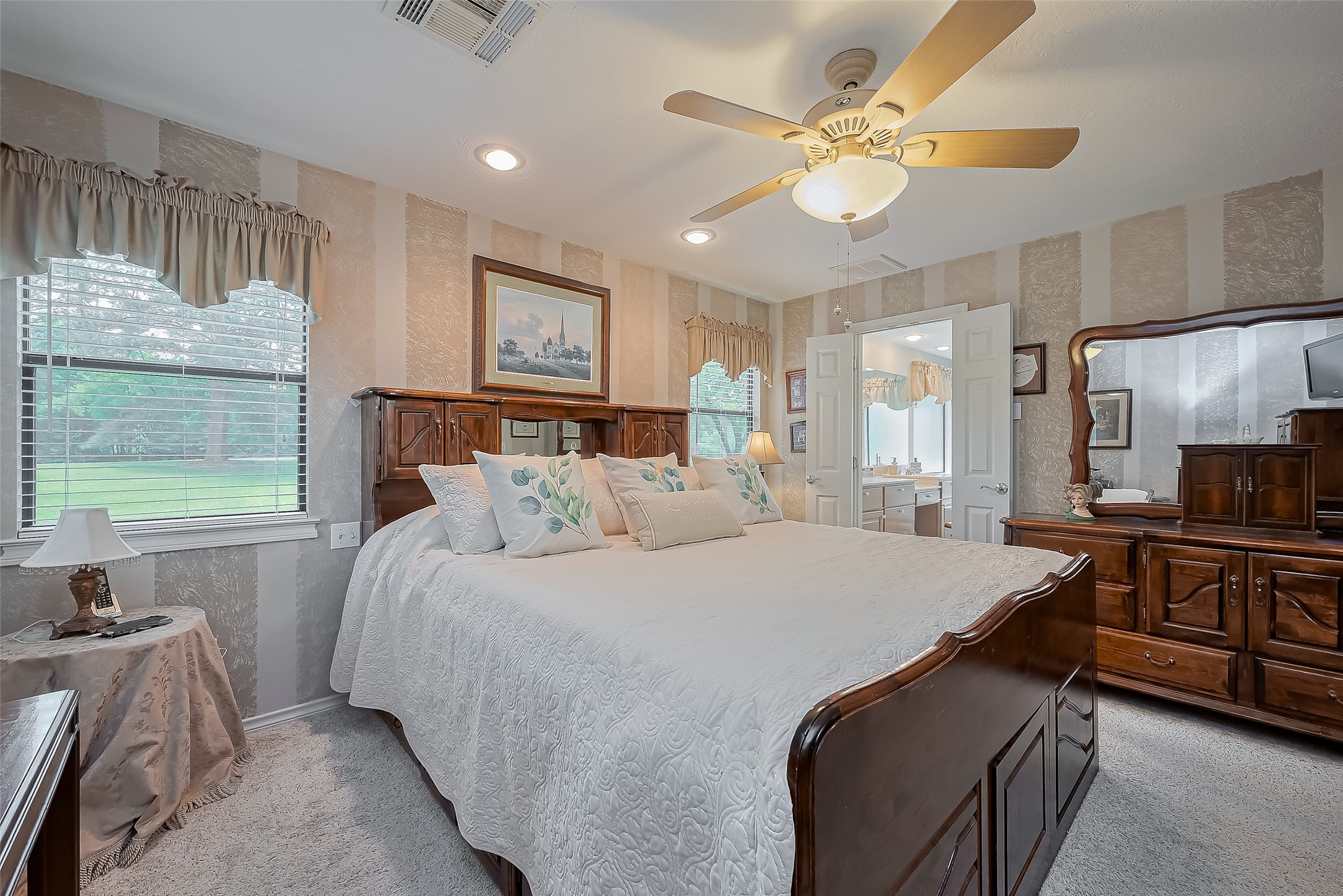 780 Hickory Ridge Drive Coldspring, TX 77331 - Photo 34 of 50 a bedroom with a large bed and a chandelier
