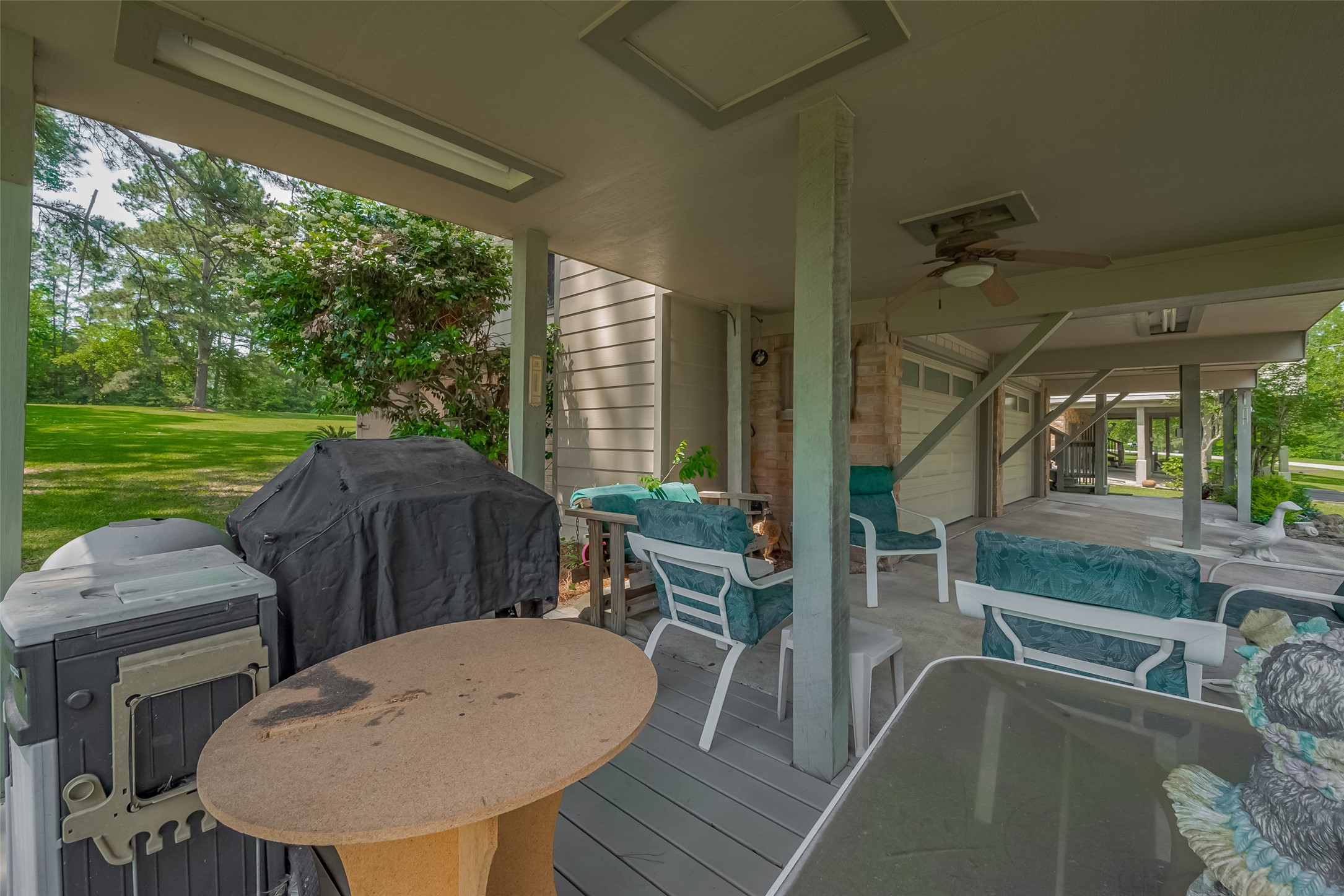 780 Hickory Ridge Drive Coldspring, TX 77331 - Photo 42 of 50 a view of a patio with a table chairs and a backyard
