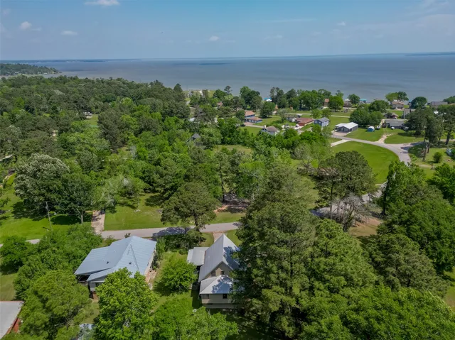 an aerial view of a house with a yard