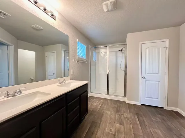 a spacious bathroom with a sink and a mirror