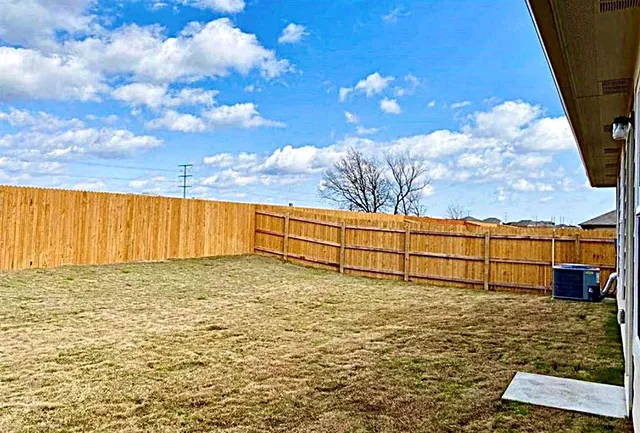 a view of a house with a large tree