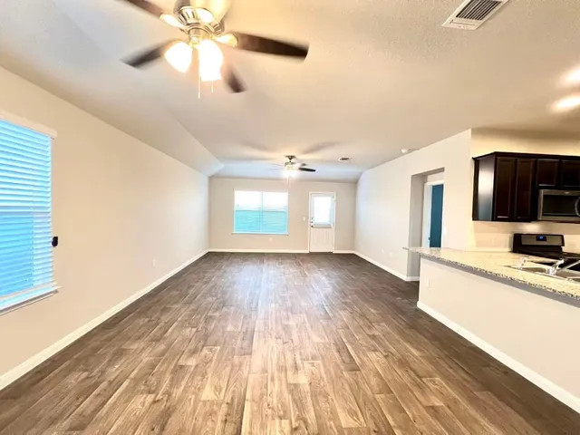 a bedroom with a large bed and a potted plant