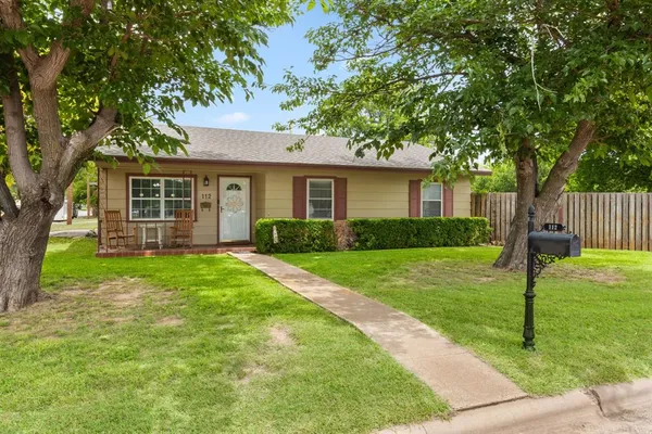 a view of a house with a backyard