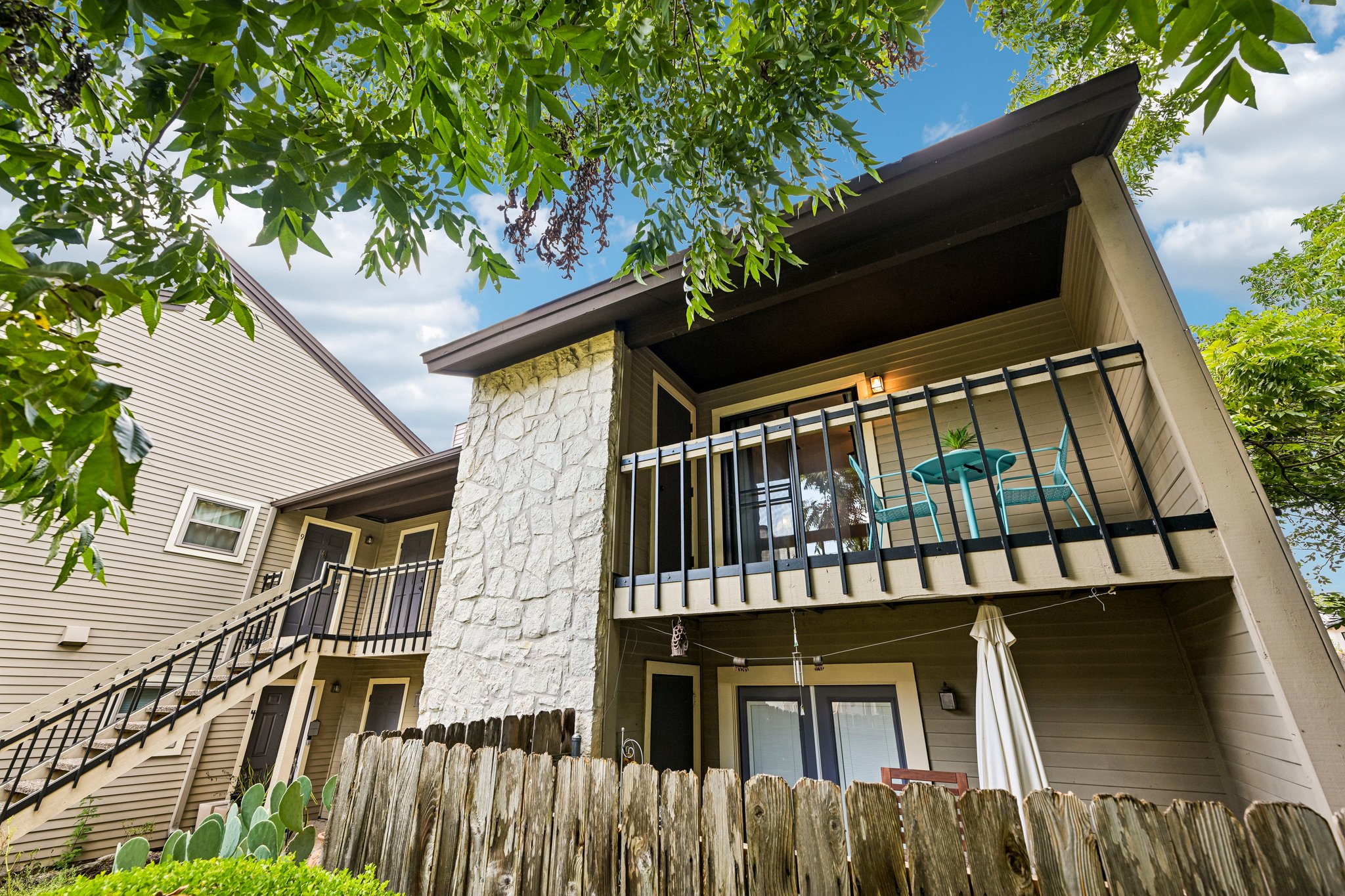 2412 Enfield Road, Unit 8 Austin, TX 78703 - Photo 30 of 34 There she is. Unit 8 sits up among the trees with a covered balcony, stone exterior accents, and that wonderfully tucked-away corner position.