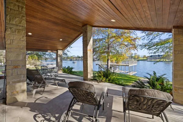 a view of a patio with chairs and potted plants