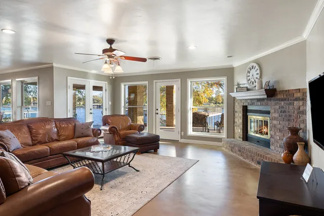 a living room with furniture a fireplace and a flat screen tv