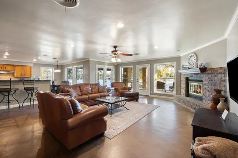 a living room with fireplace furniture and a wooden floor