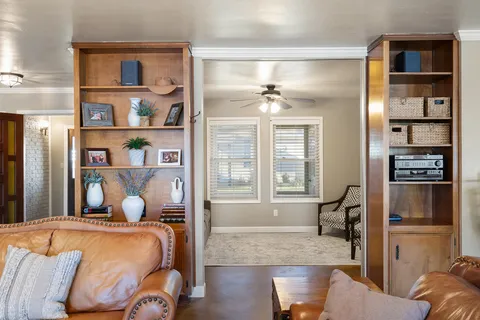 a bedroom with a bed cabinets and window