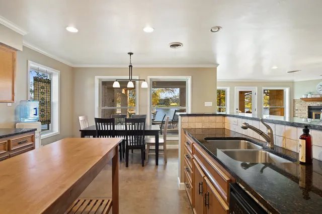 a kitchen with a table chairs stove and cabinets
