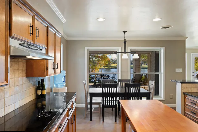 a dining room with furniture a chandelier and wooden floor