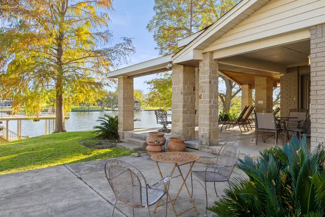 a view of a backyard with plants and patio