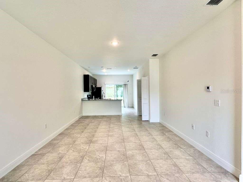15885 Southwest 35th Court Road, Unit 2 Ocala, FL 34473 - Photo 3 of 21 a view of a big room with wooden cabinet and windows