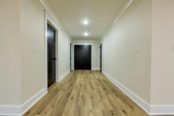 a view of hallway with wooden floor