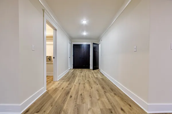 a view of hallway with wooden floor